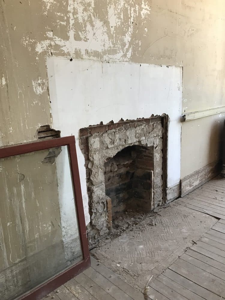 old fireplace with missing mantel and tile work