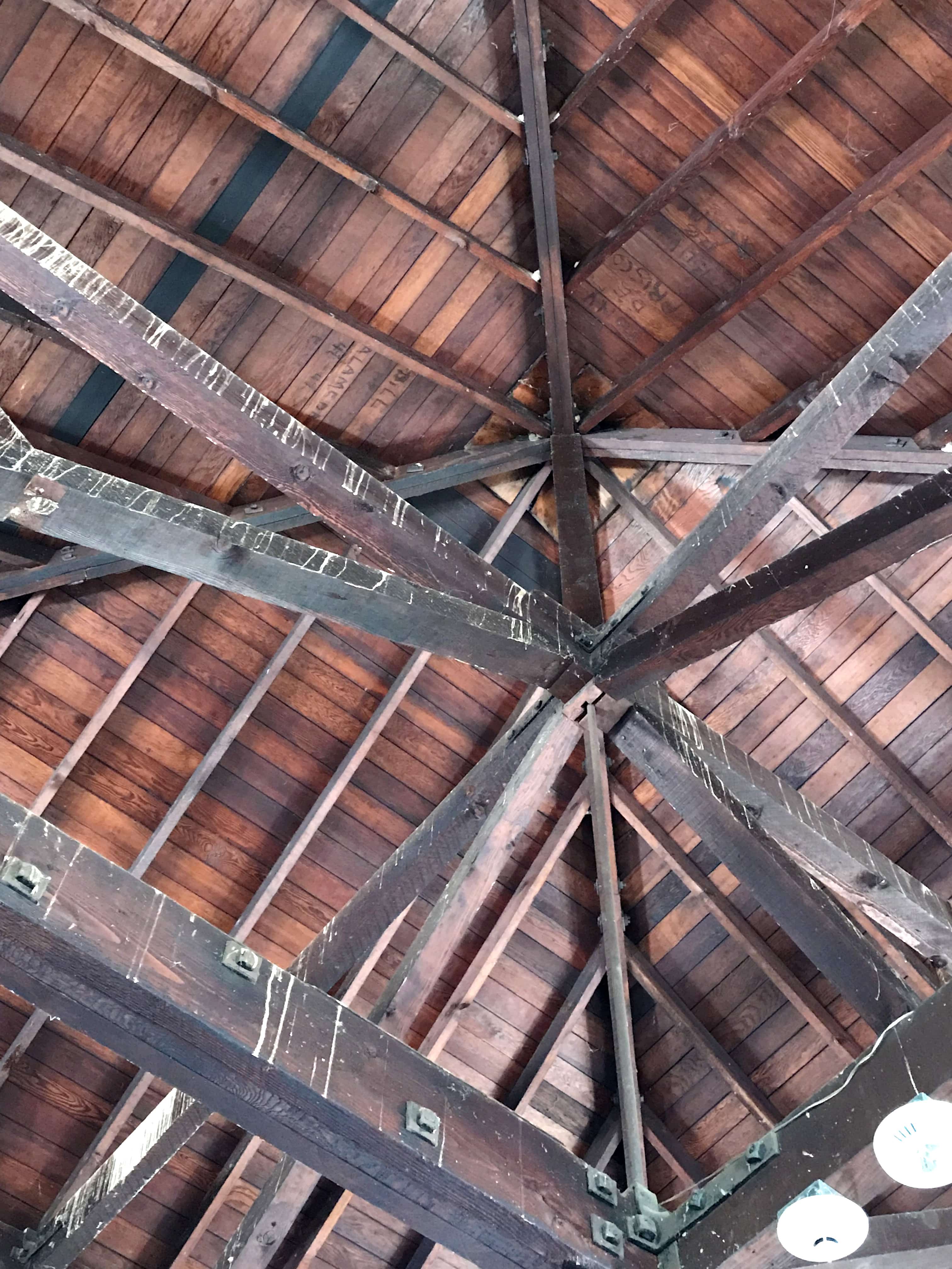 wooden ceiling and beams with names carved into them