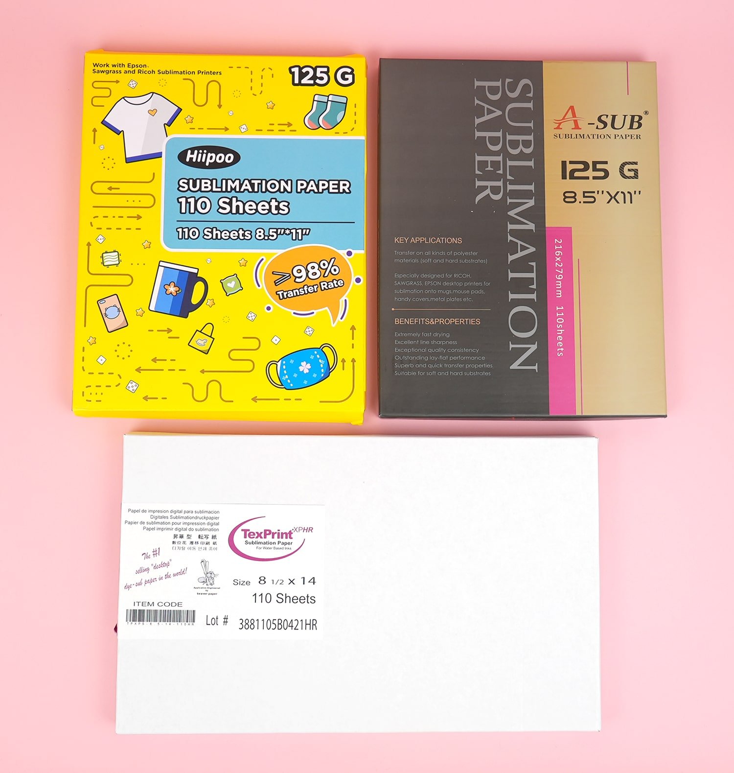 3 boxes of different brands of sublimation transfer paper on a pink background
