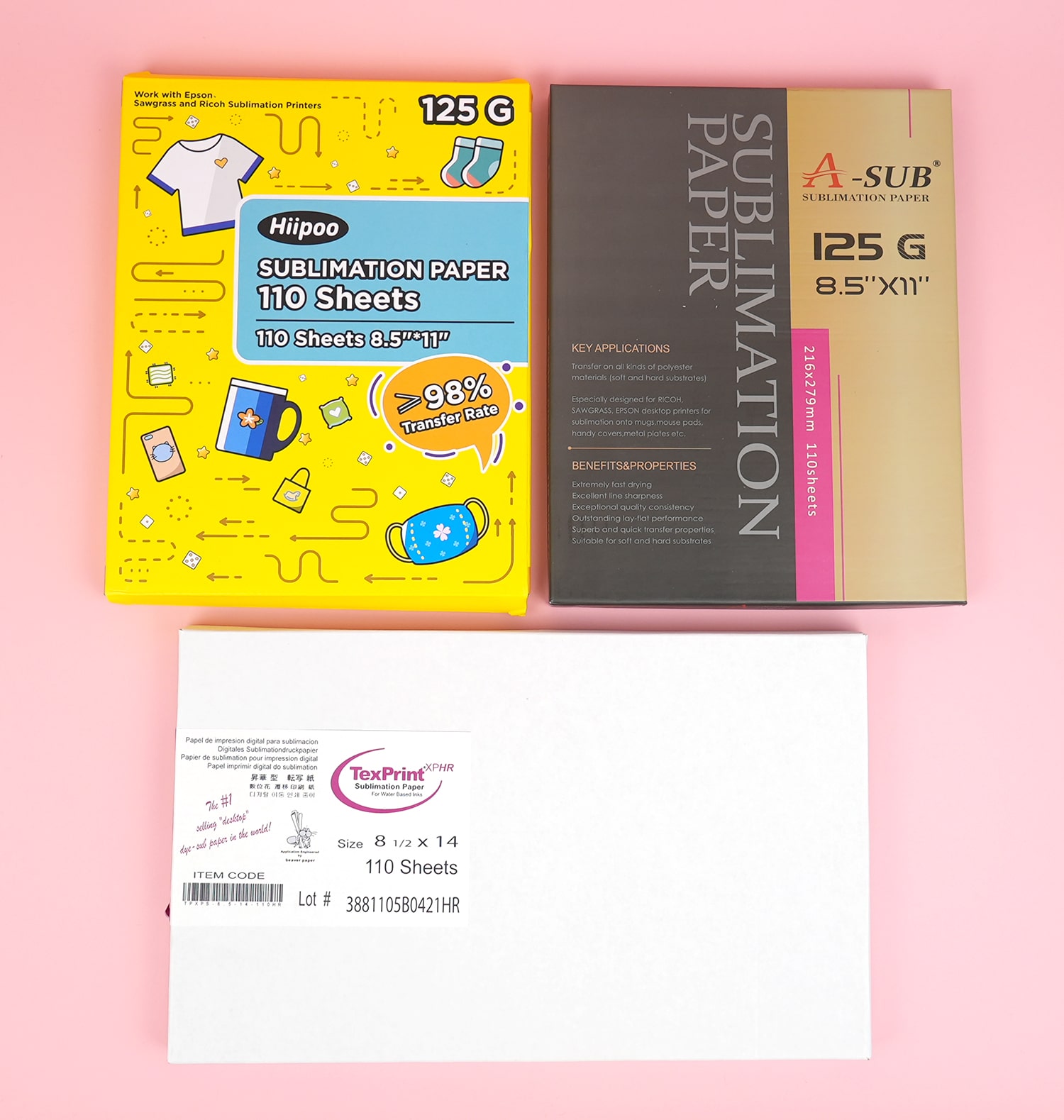 3 boxes of different brands of sublimation transfer paper on a pink background