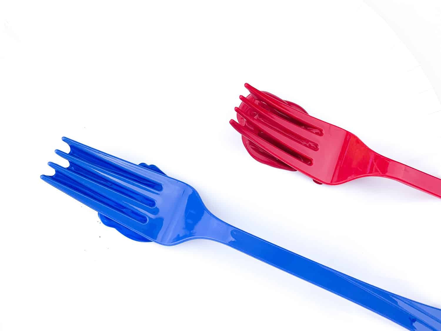 blue and red painted forks on white paper plates