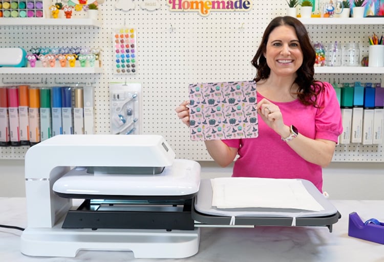 heidi from happiness is homemade demonstrating a sublimation transfer sheet next to HTV