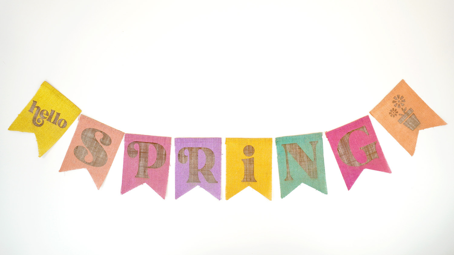 Colorful "Hello Spring" laser engraved burlap banner pieces on a white background