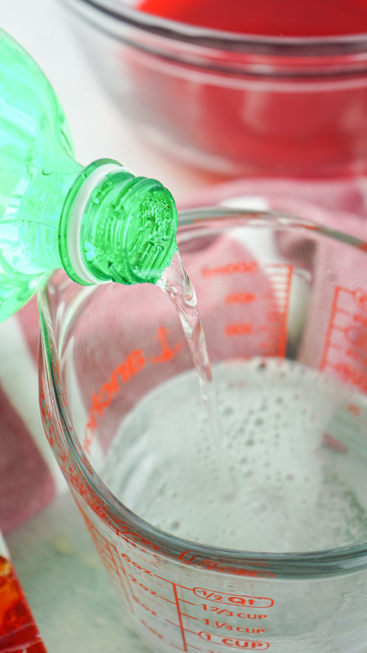 lemon lime being poured into measuring cup