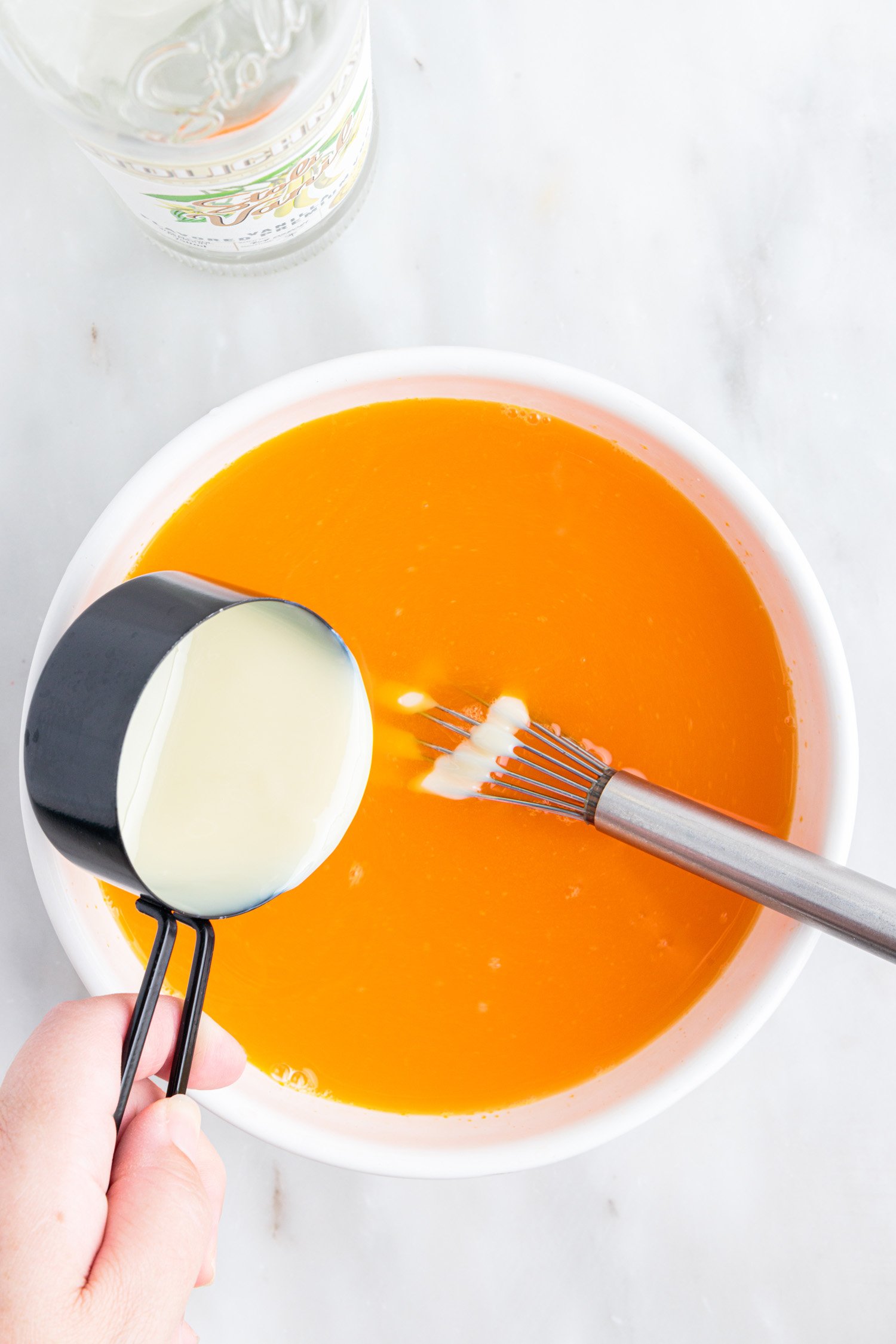 adding ingredients to bowl for unique jello shots