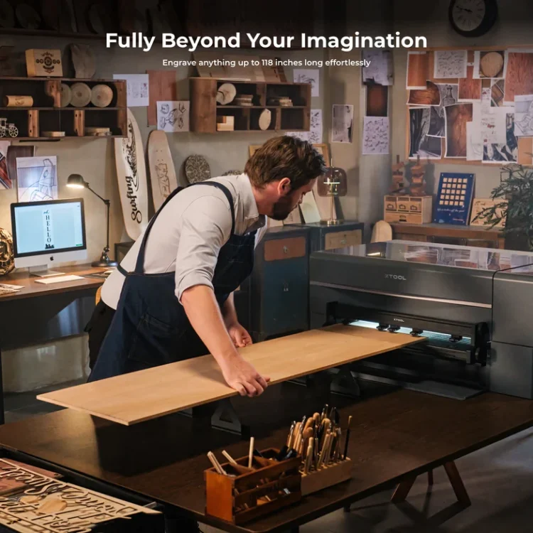 Man in apron using the xTool P2 Automatic Conveyor to engrave a long piece of wood