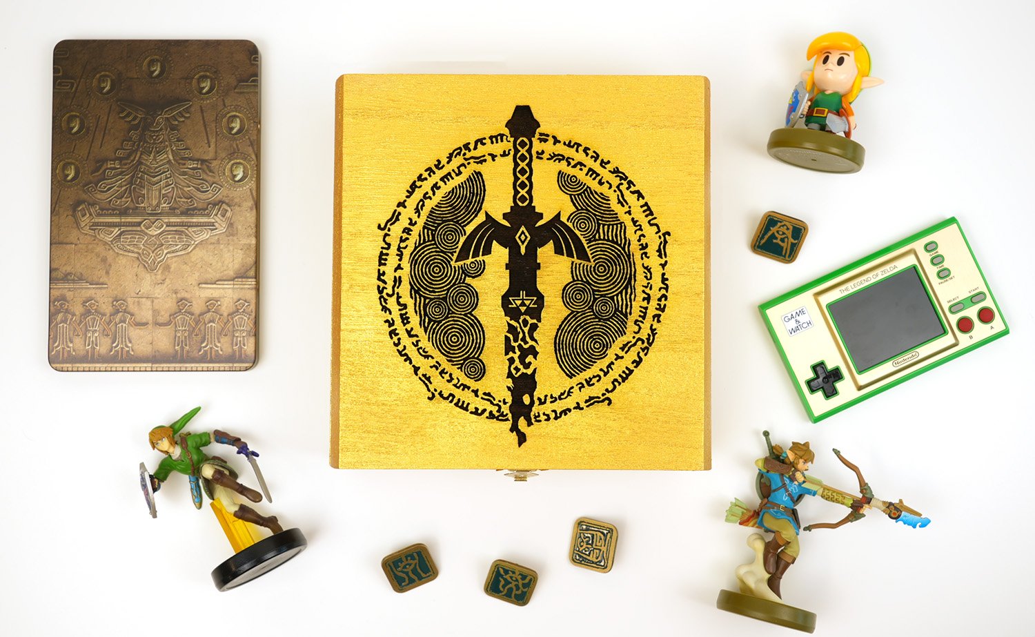 Gold Box engraved with a Legend of Zelda design surrounded by Zelda toys