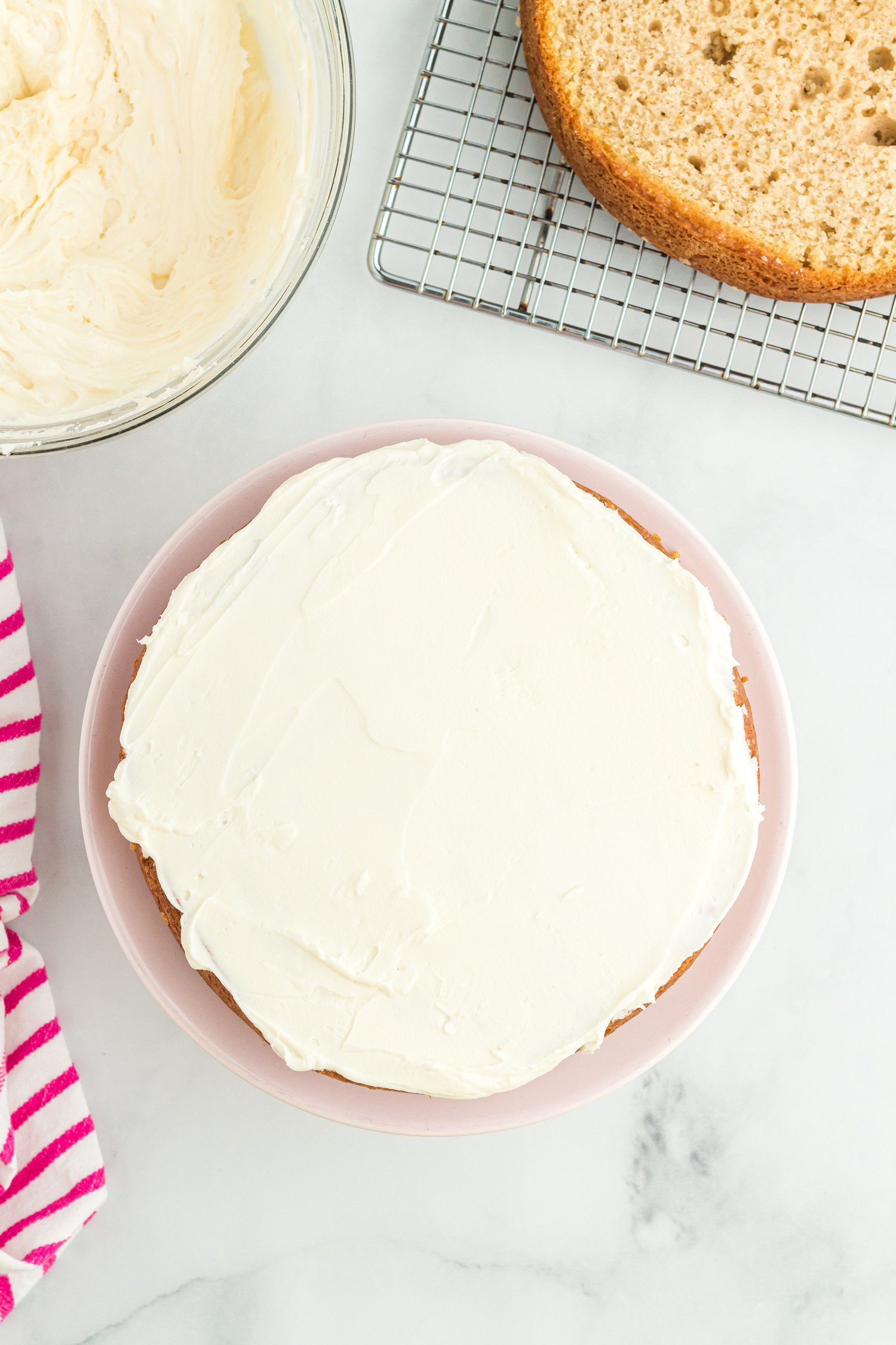 frosting added to layer of round cake