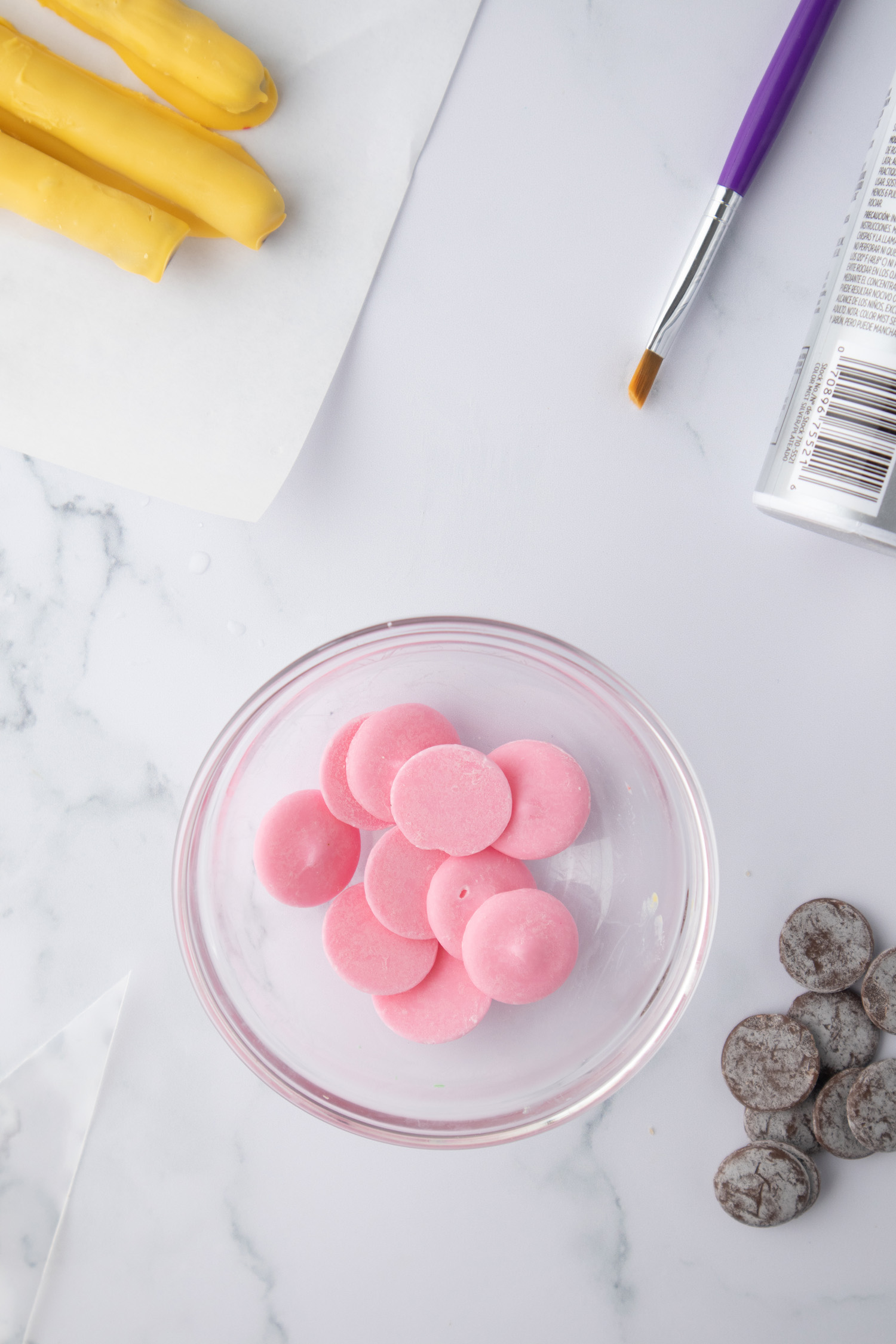 pink chocolate candy melts in bowl with supplies