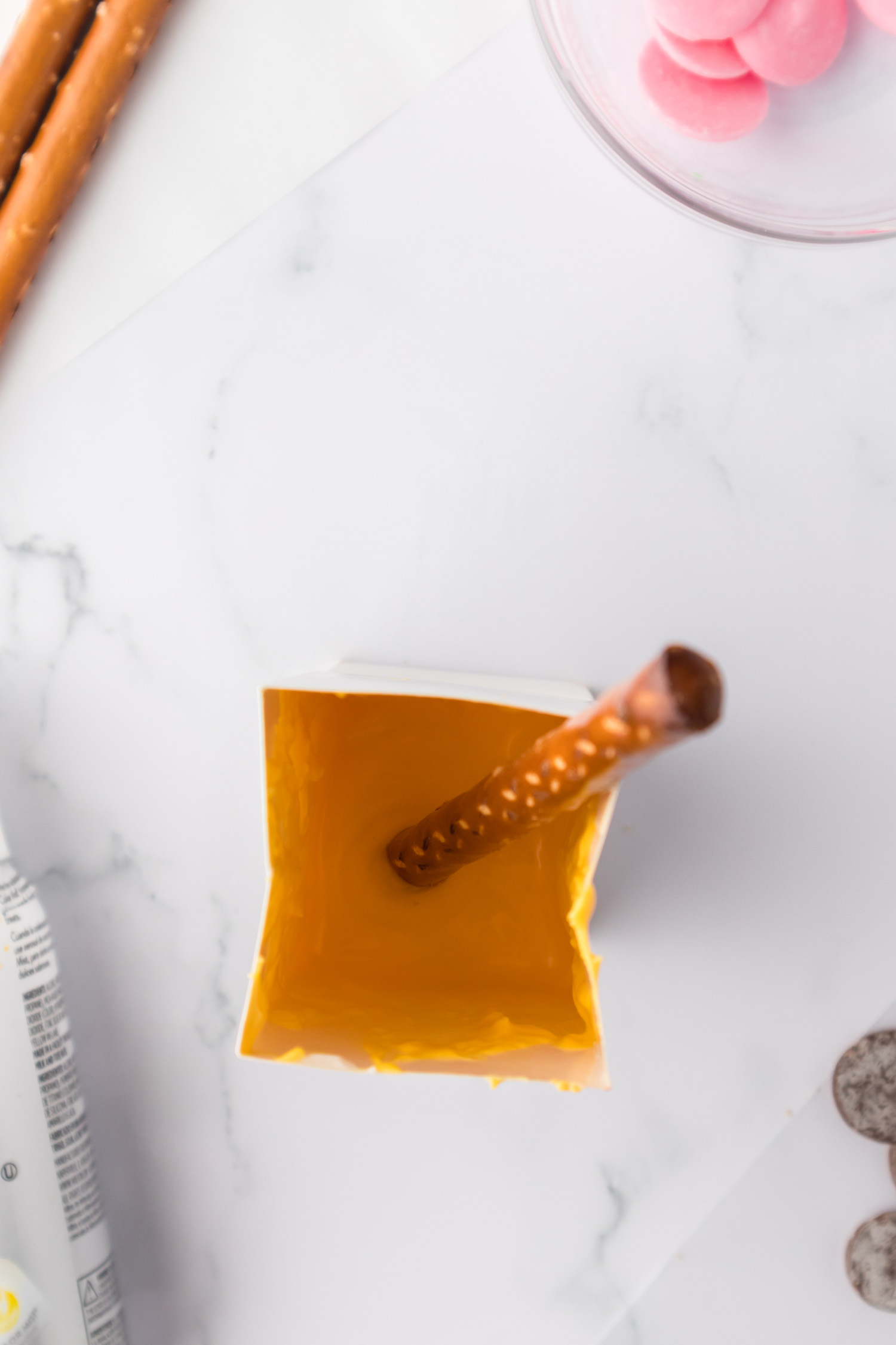 dipping pretzel into bowl of chocolate