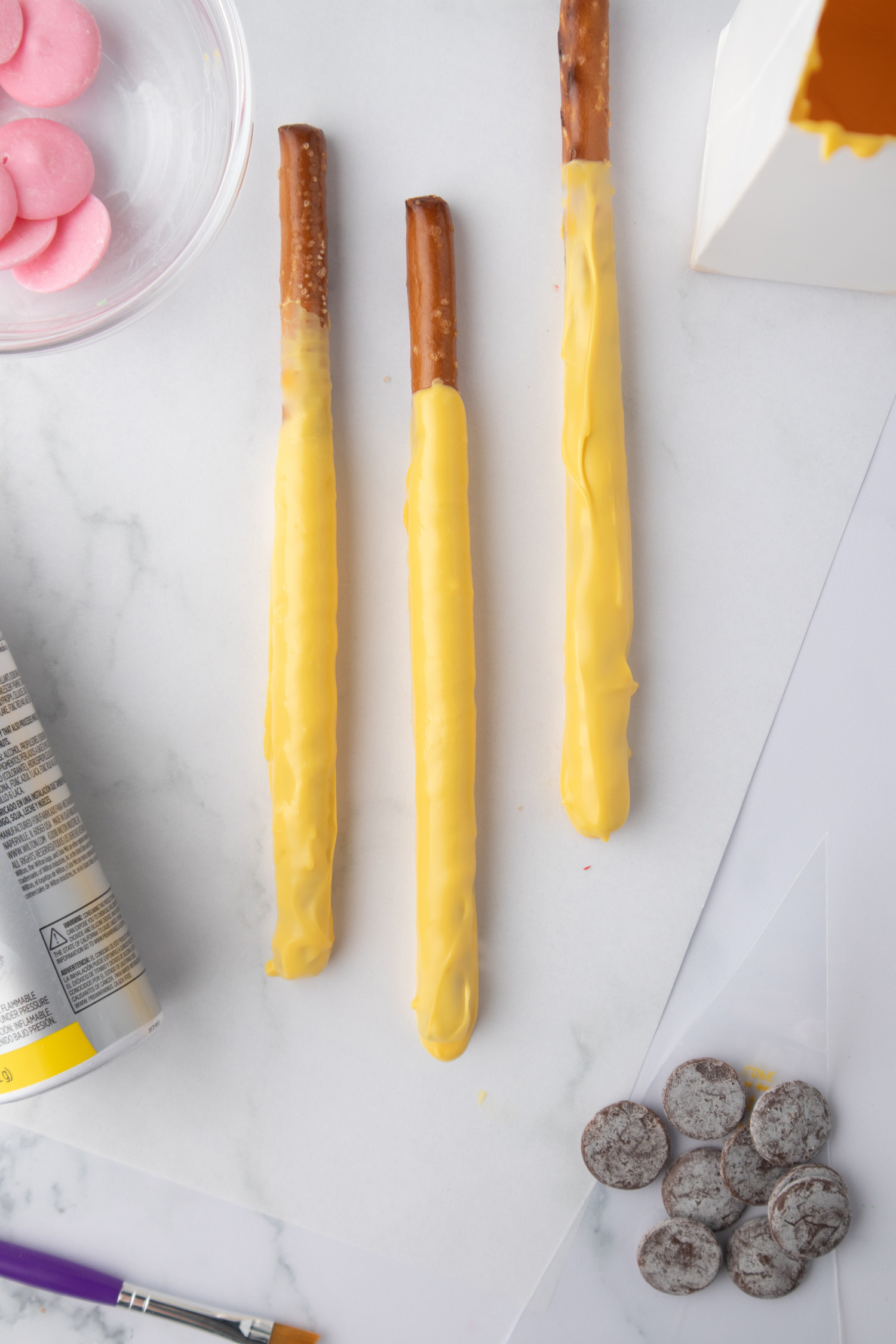 long straight pretzels dipped into yellow chocolate