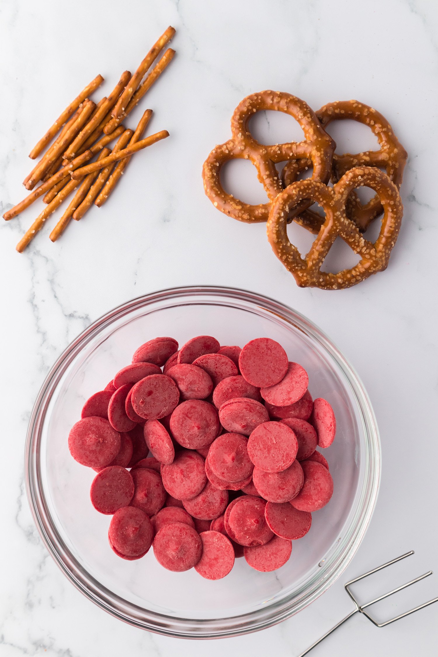 red chocolate wafers in bowl and pretzels