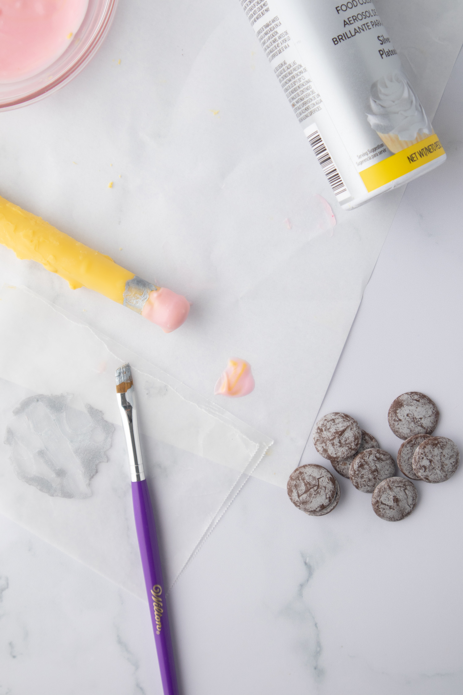 DIY chocolate covered pretzel pencil being assembled