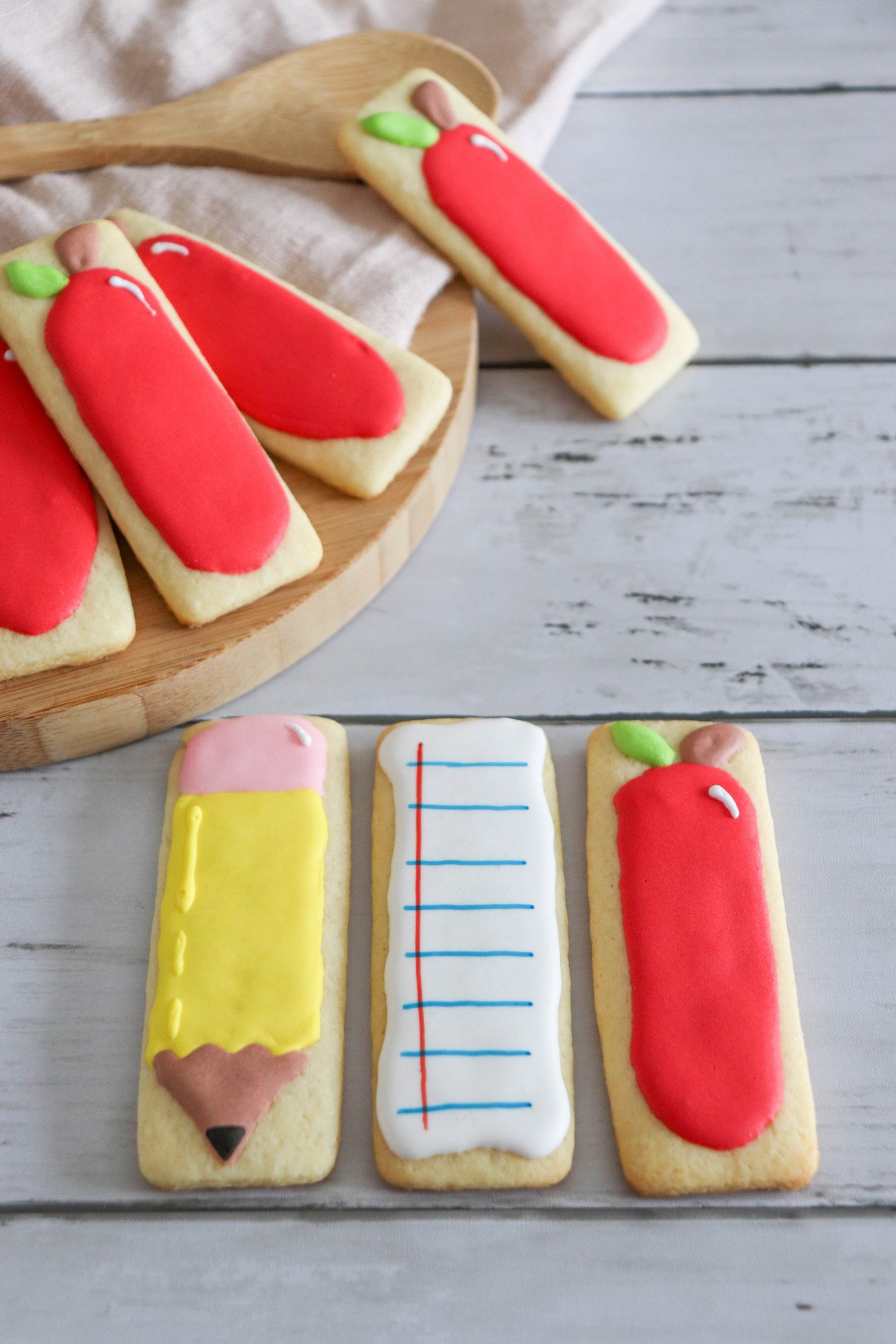 pencil, apple, and lined notebook paper designs on sugar cookies