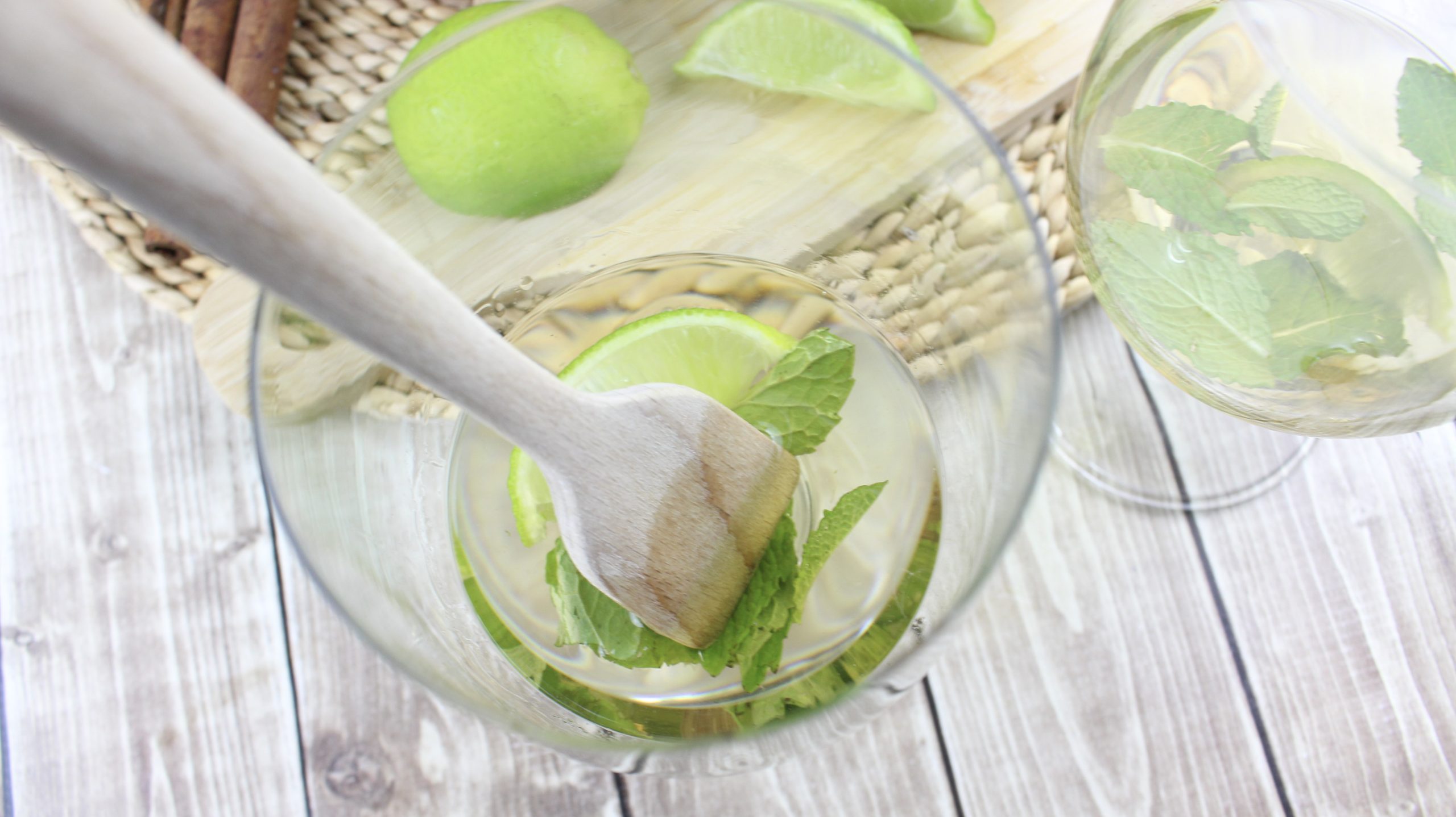 fork mixing up ingredients for easy mojitos in cocktail glass