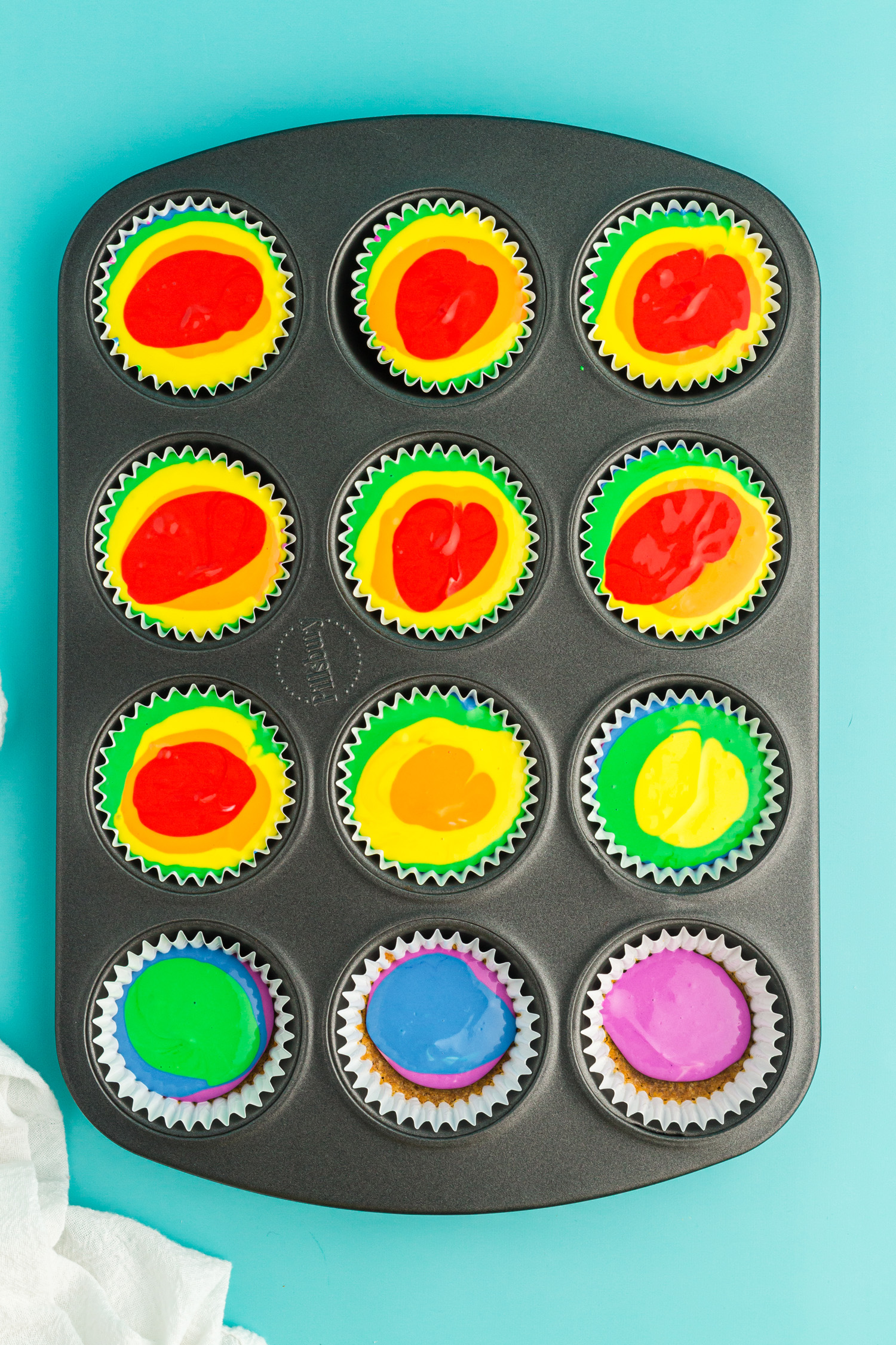 layers of colors added to muffin tin