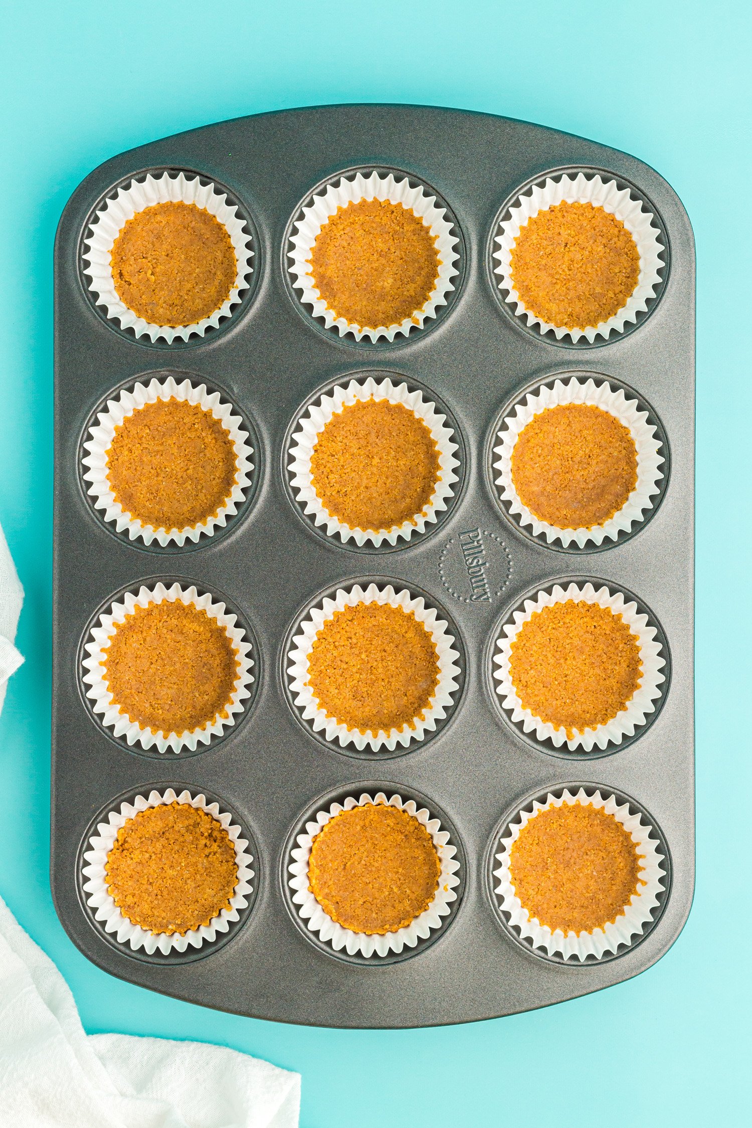 baking tin full of cupcake liners with graham crackers