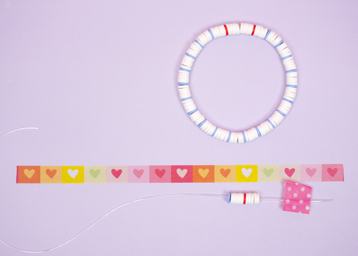 "Notebook Paper" inspired cleay bead bracelet and beading pattern on purple background