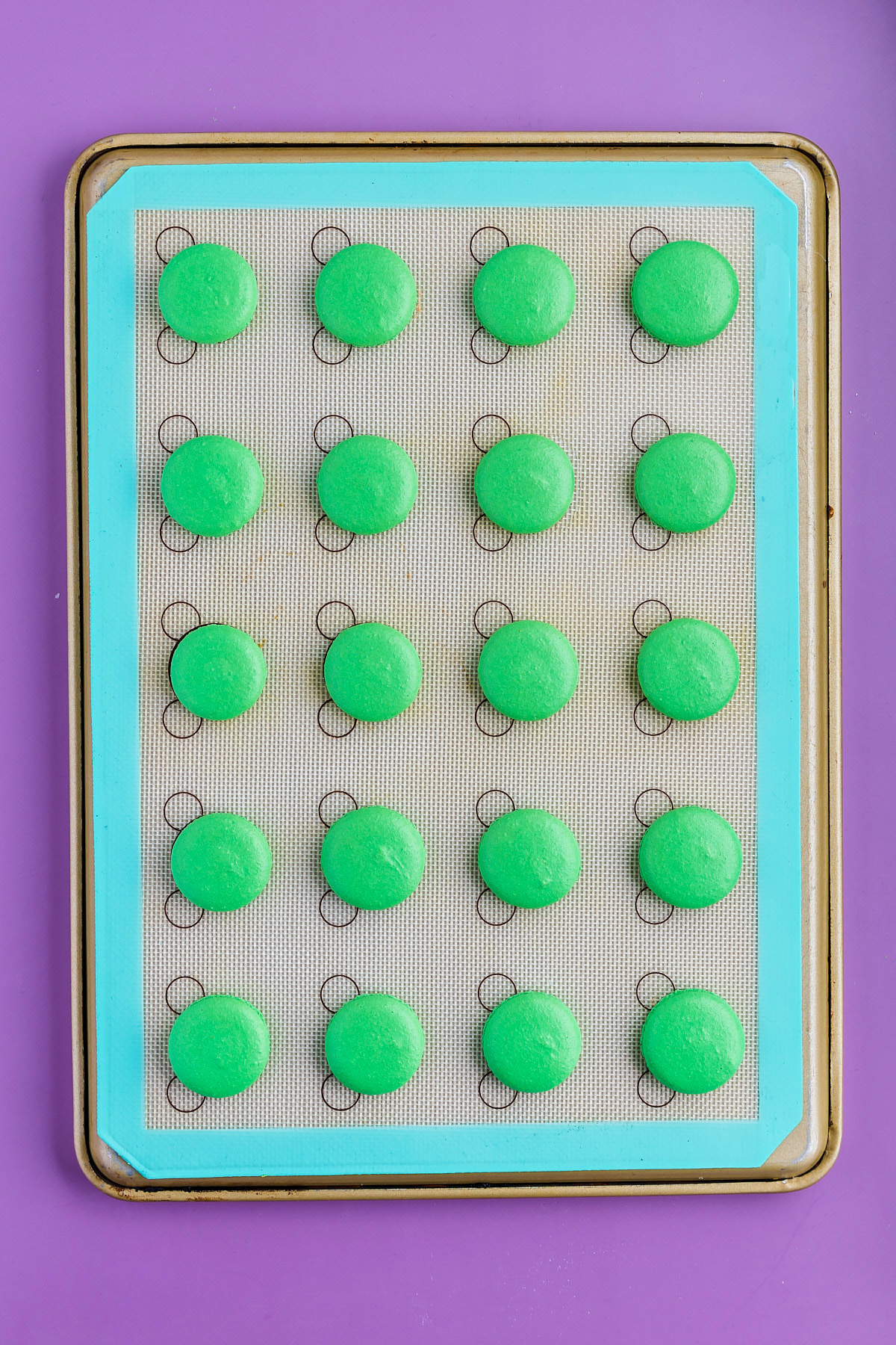macaron cookies piped onto tray