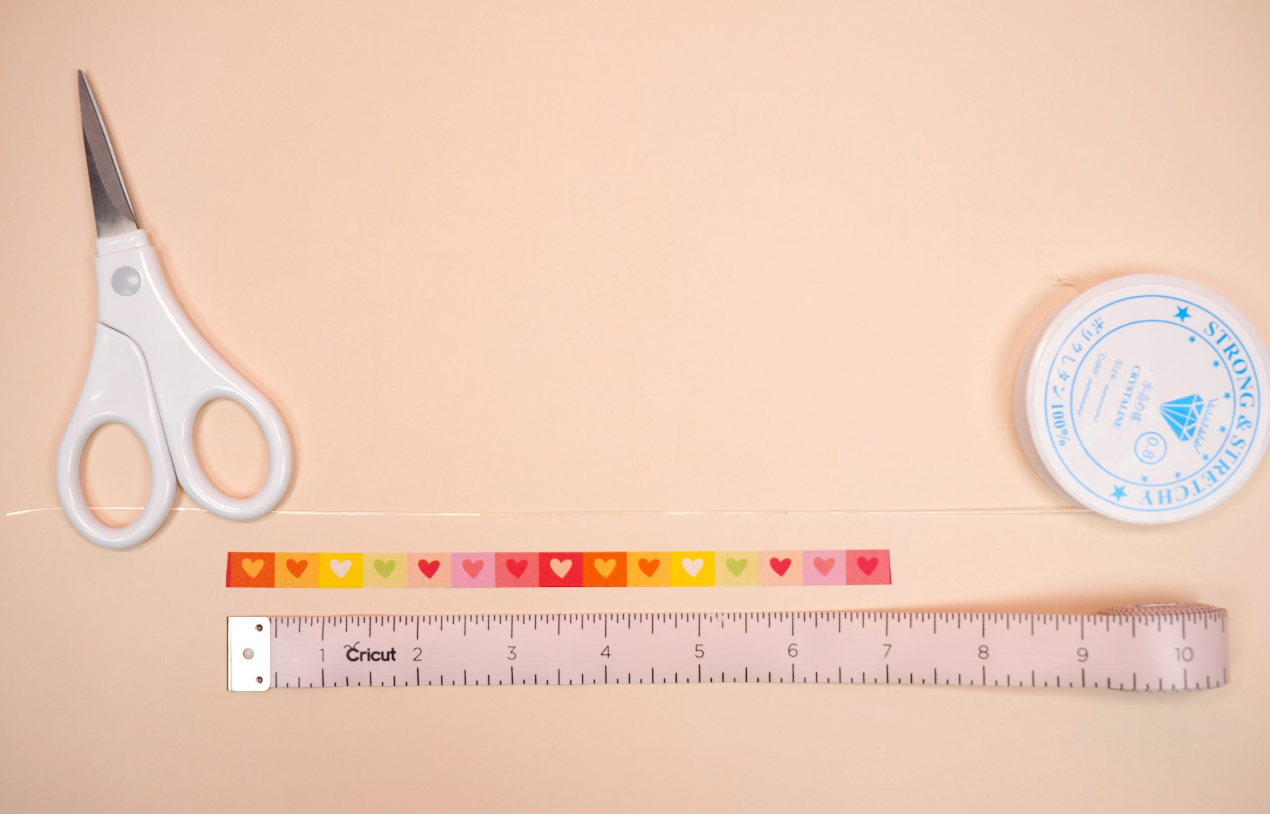 Stretchy bracelet cord being measured against a 7" soft tape measure 