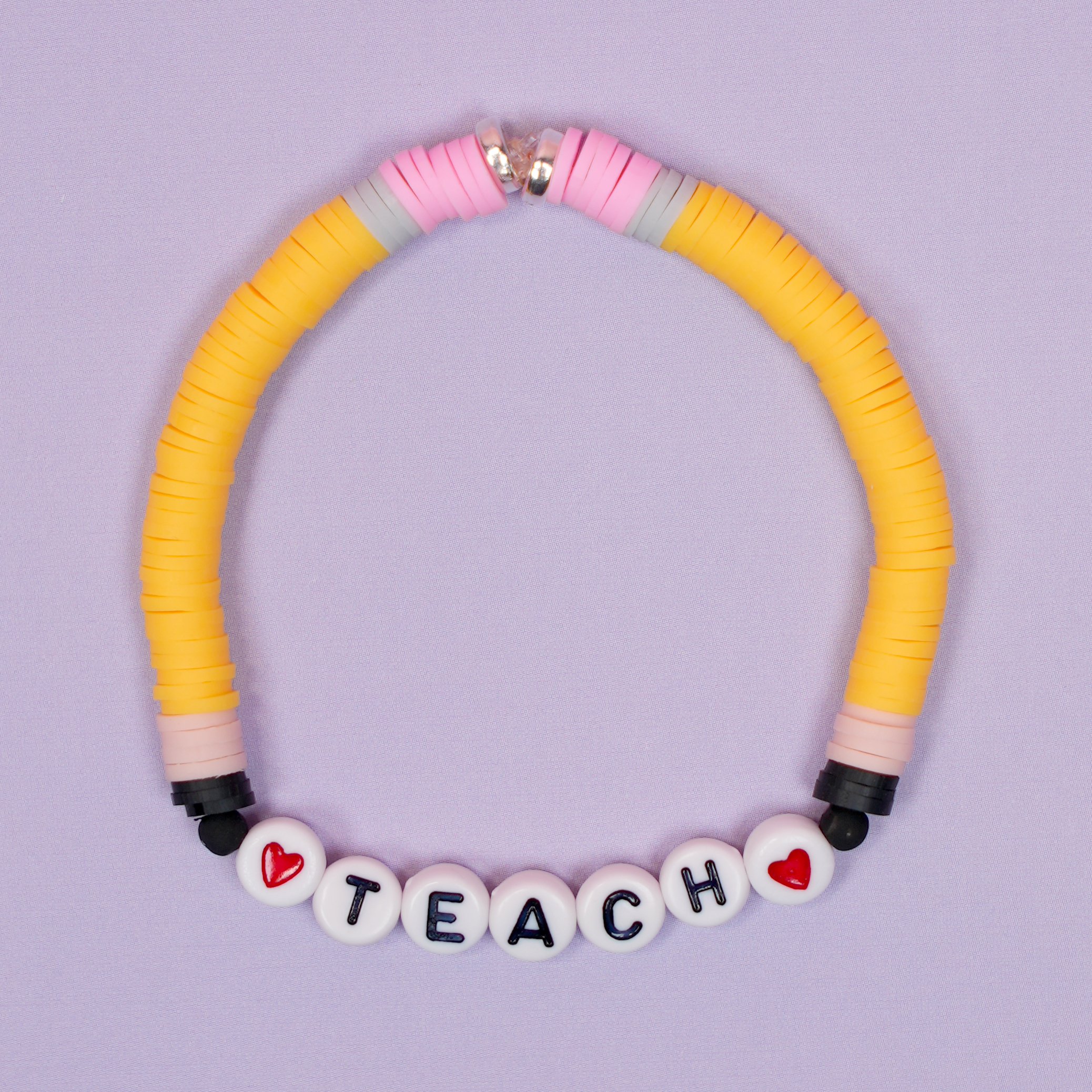 Teacher clay bead bracelet with pencil-inspired design on purple background