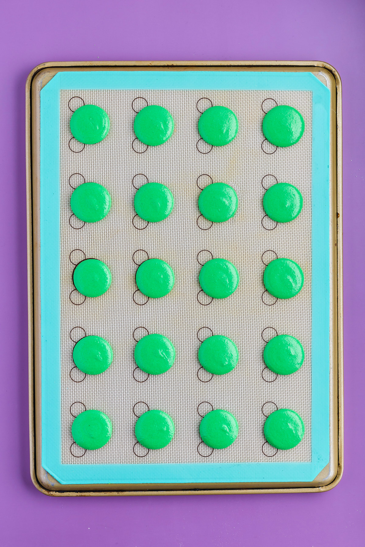 frankenstein macaron cookies piped onto tray