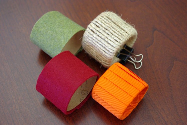 Cardboard tubes covered in felt and twine held together by a binder clip