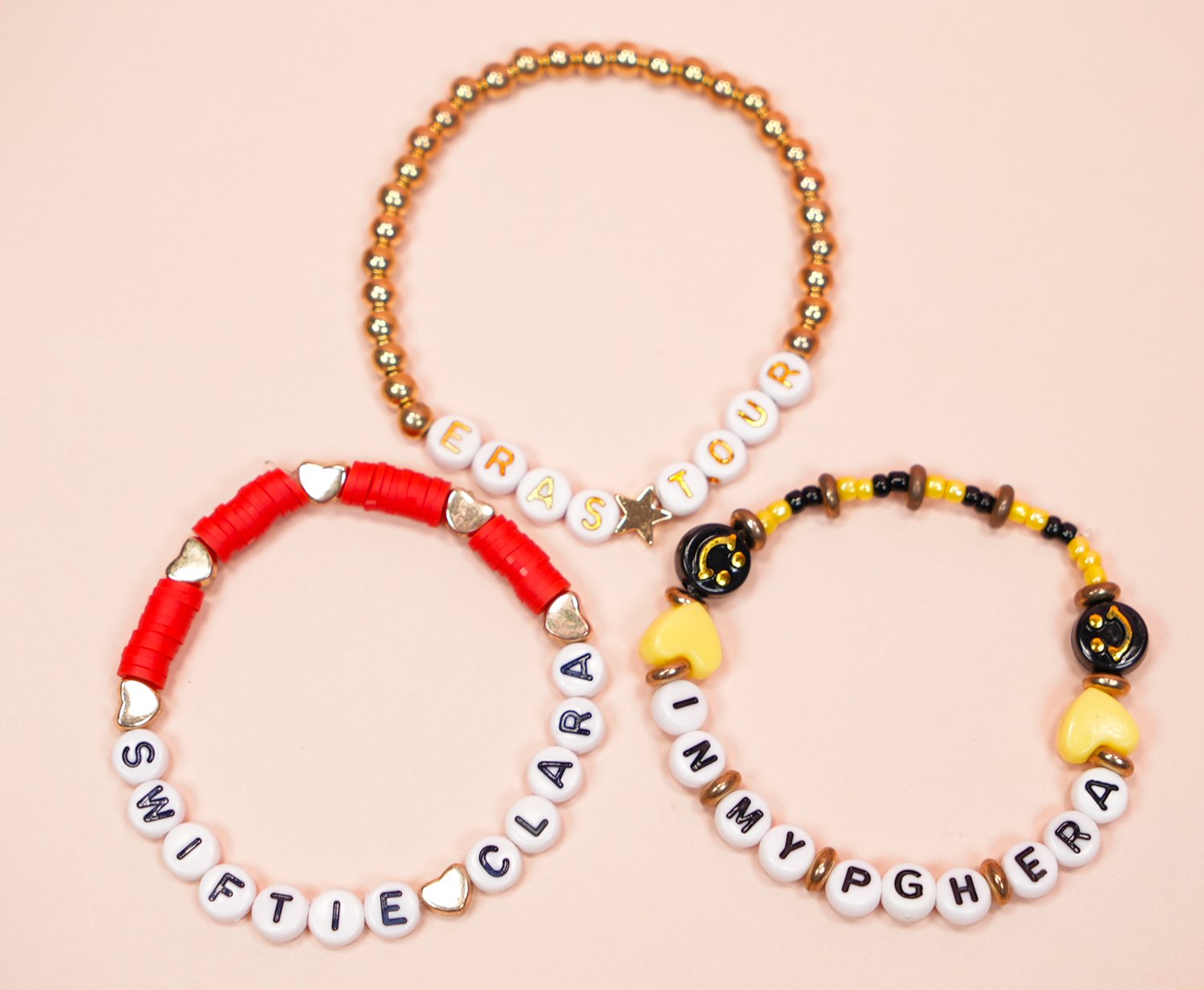 Three Taylor Swift friendship bracelets featuring "Eras Tour" and two concert locations