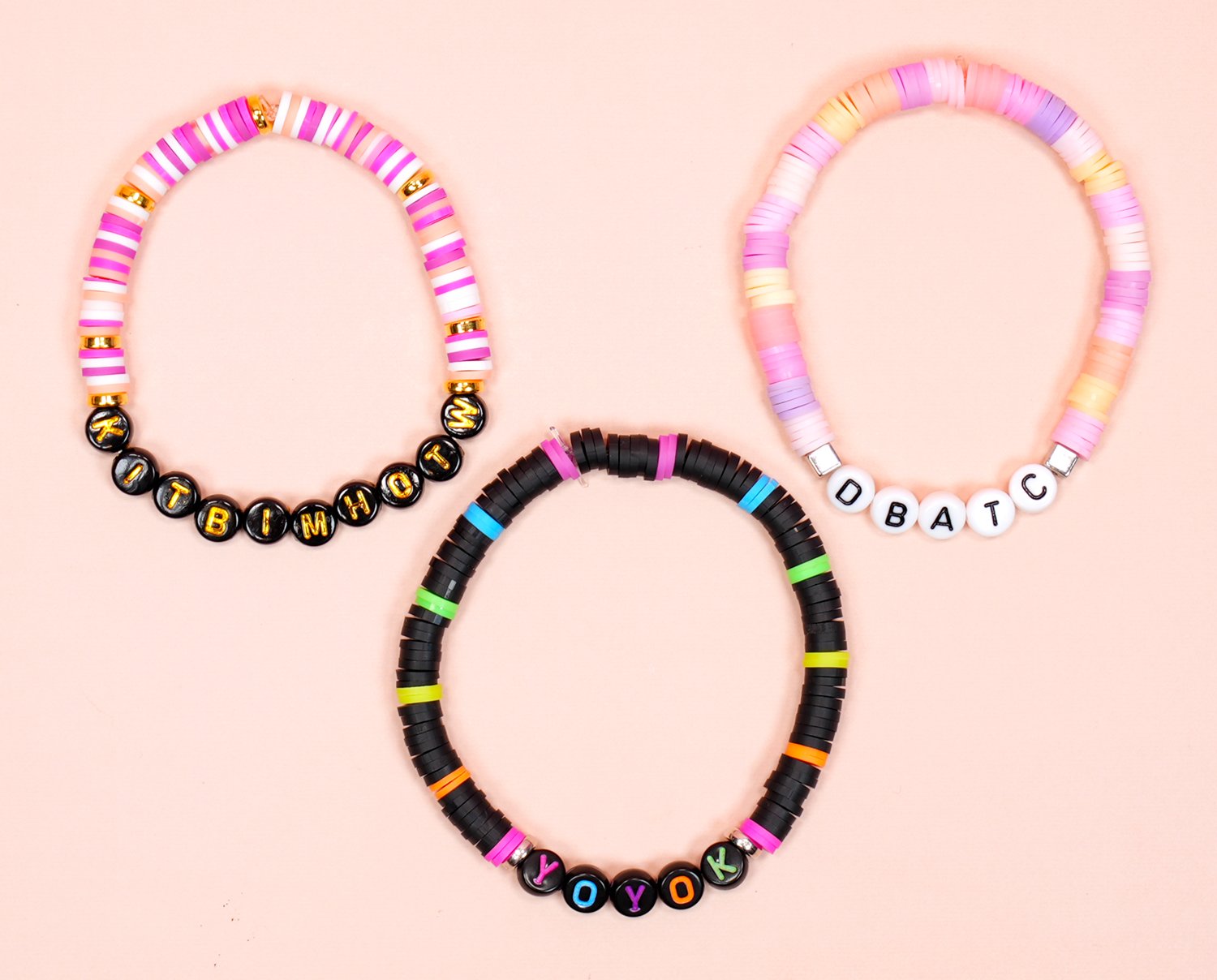 Three colorful Taylor Swift Eras Tour friendship bracelets featuring acronyms from song titles and lyrics