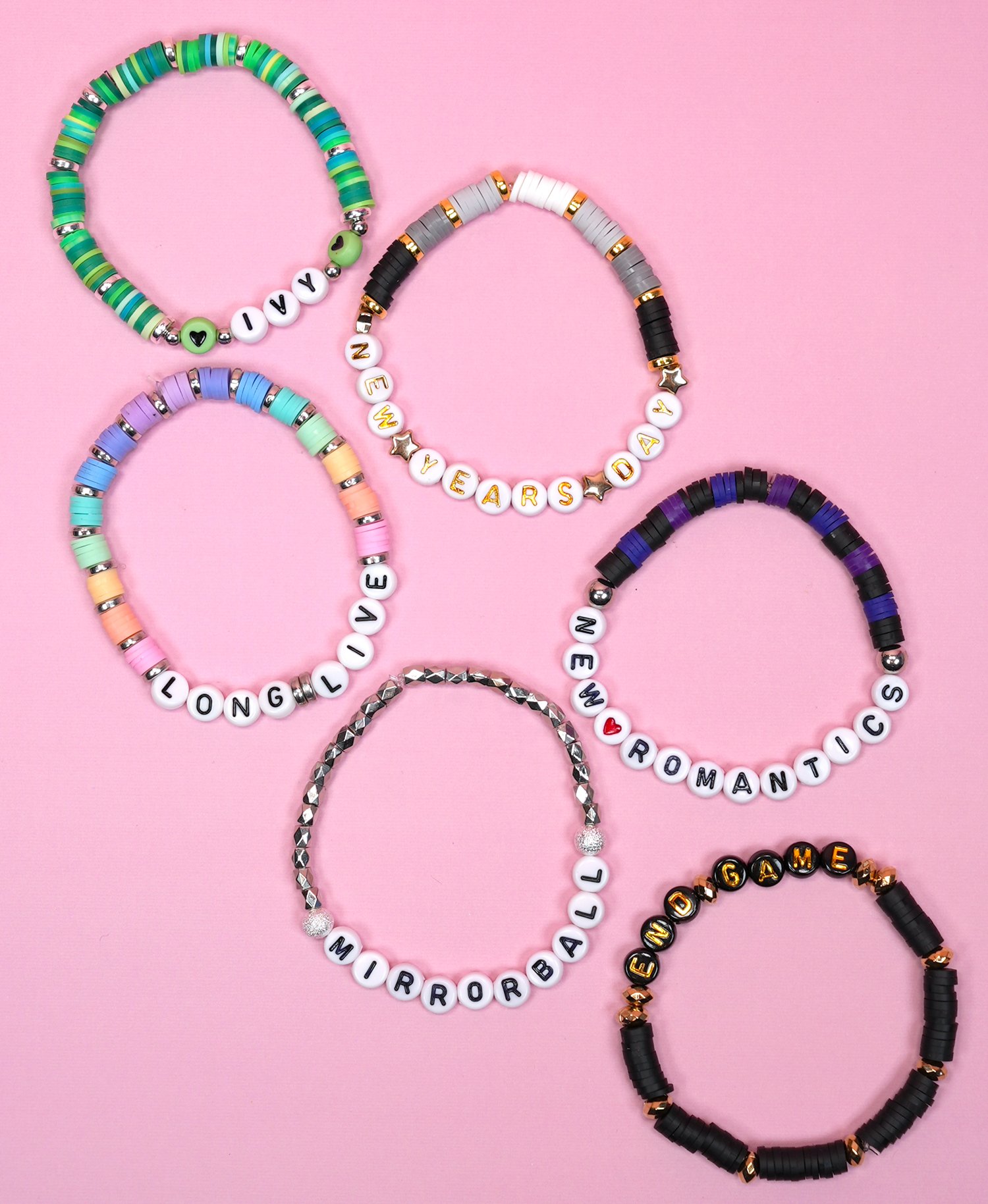 Six colorful beaded bracelets with Taylor Swift "surprise song" song titles on pink background