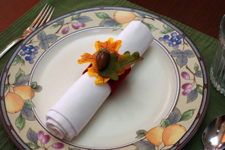 Thanksgiving napkin rings on a floral plate