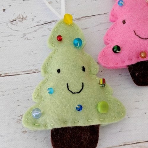 two felt smiling christmas tree ornaments