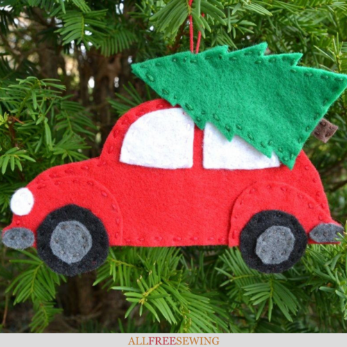 vintage red car with christmas tree ornament hanging on a Christmas tree