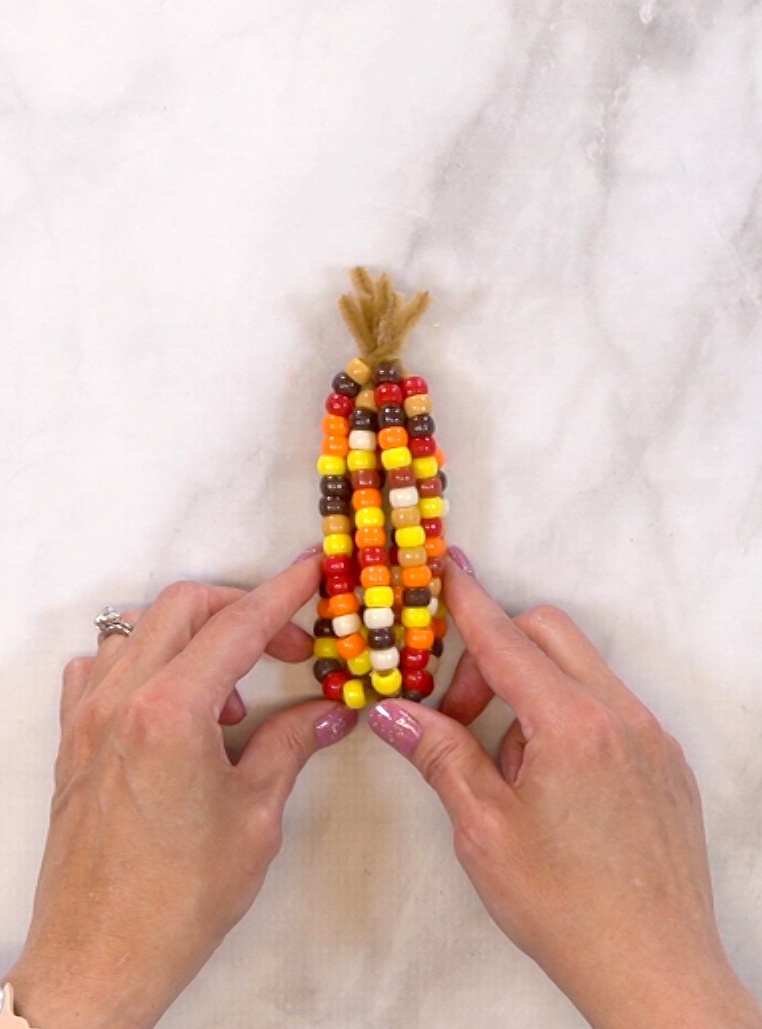 hands showing finished harvest corn project