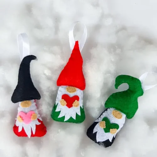 felt gnome ornaments on white fluffy background