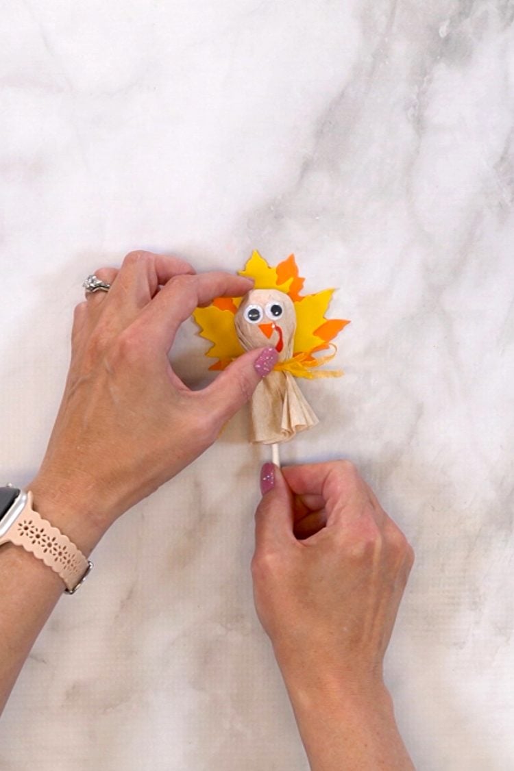 placing googly eyes on diy turkey treat