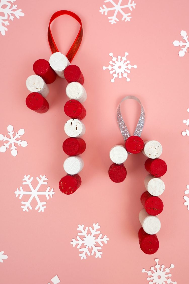 two DIY candy cane ornaments with snowflakes