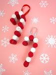 homemade wine cork ornaments on pink background