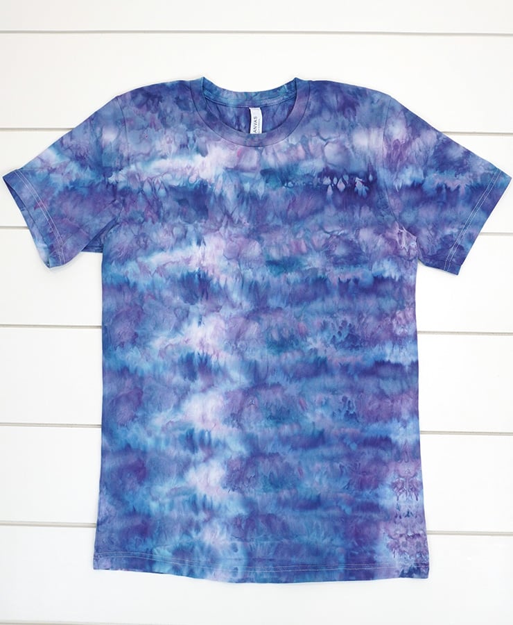 Purple and dark blue ice dyed shirt with honeycomb pattern on white wood background