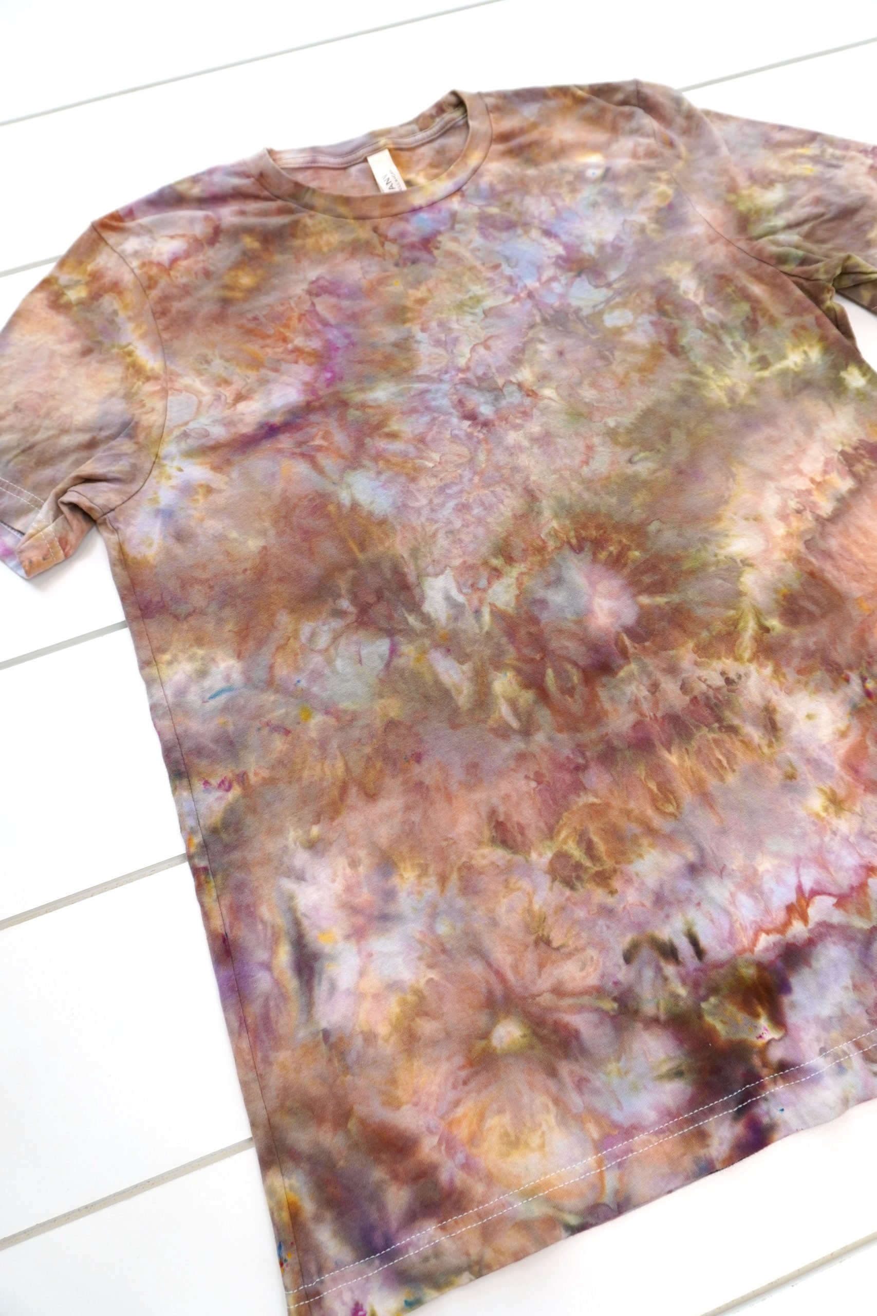 Close up of multi-hued brown tie-dye ice dye shirt with many colors