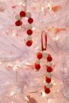 two cute white and red ornaments on tree
