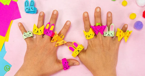 hands decorated with paper animal origami rings