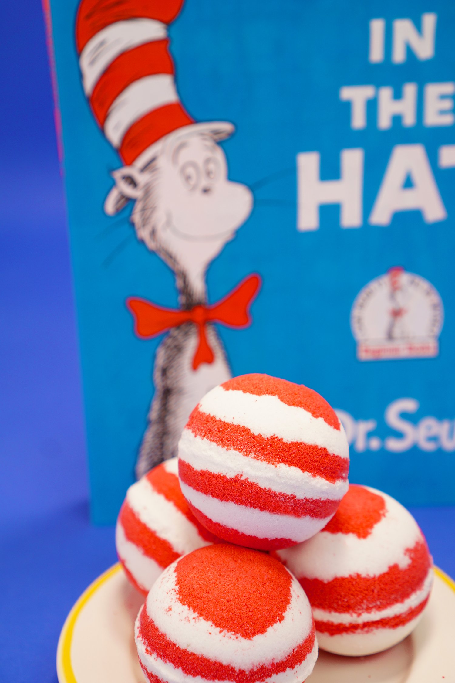 DIY red and white bath bombs with Cat in the Hat book on blue background