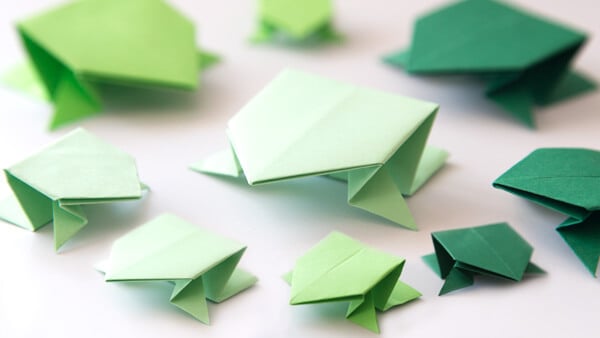 jumping origami frogs in various shades of green