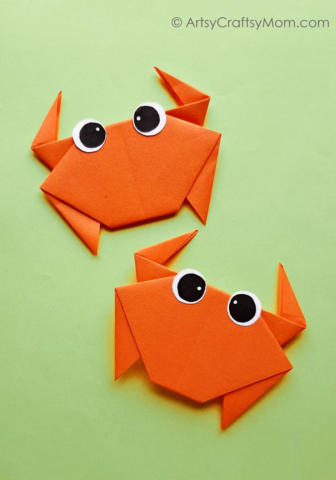 two cute orange origami crabs 