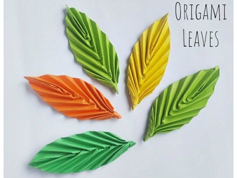 origami folded leaves in different colors of autumn and green