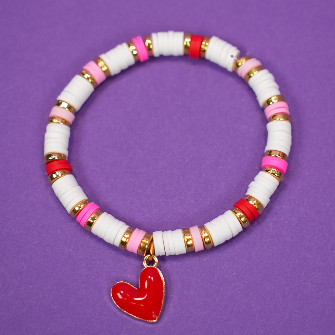 Valentine's Day bracelet with white beads, gold spacers, colorful pink and red accents, and a red heart charm