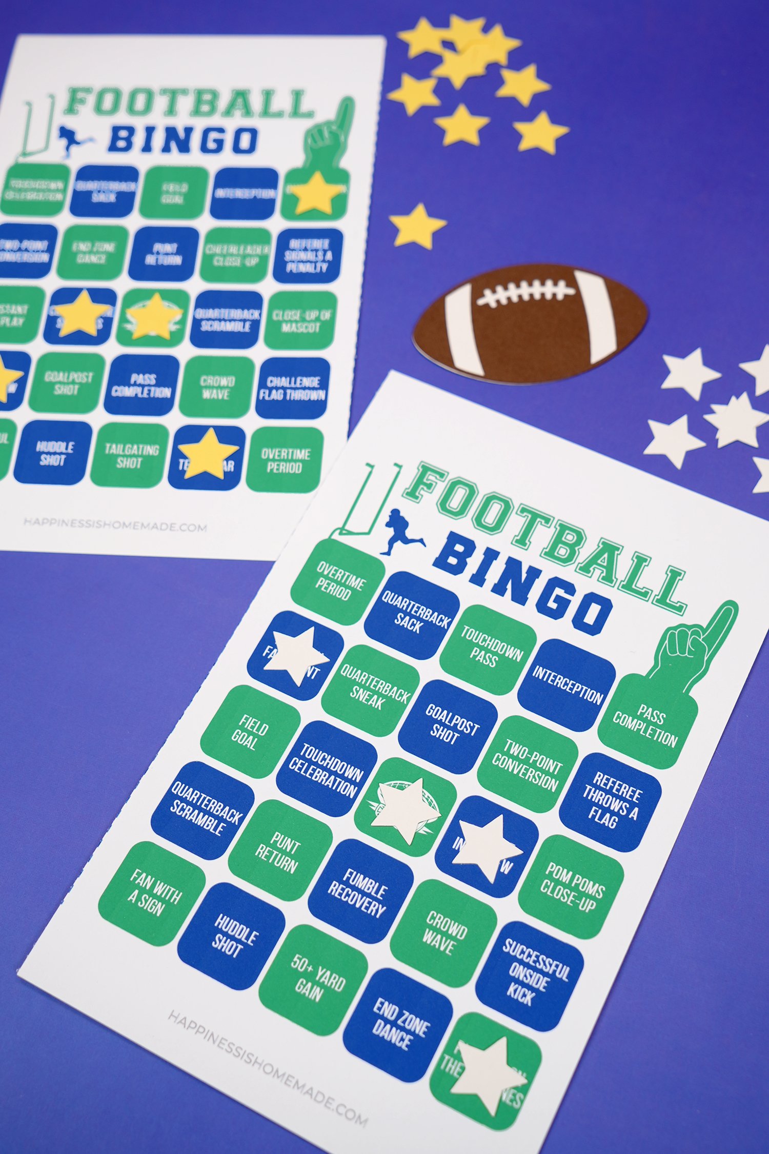 Close up of green and blue football bingo game cards with star markers on blue background