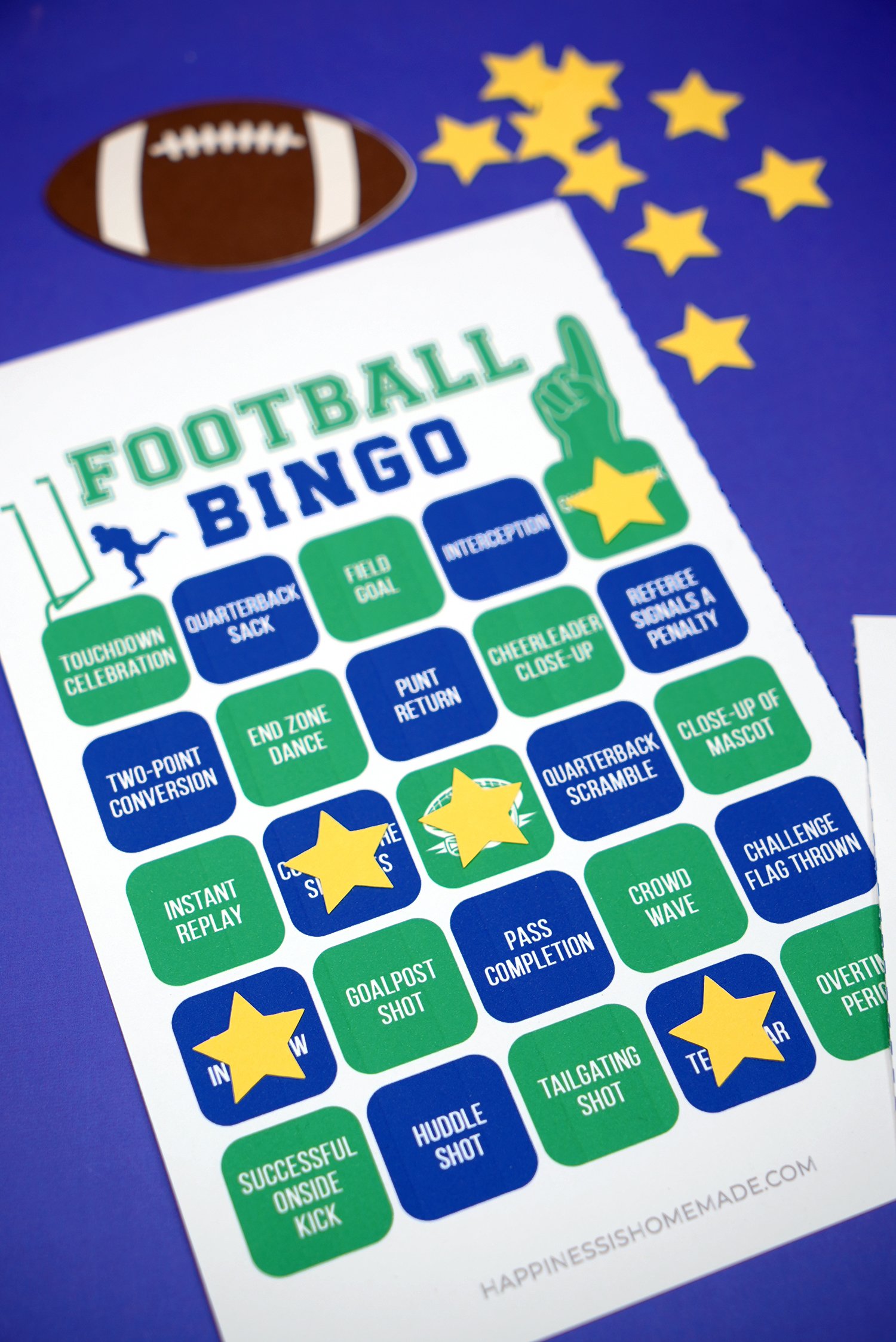 Close up of green and blue free printable football bingo game card with yellow star markers and football on blue background
