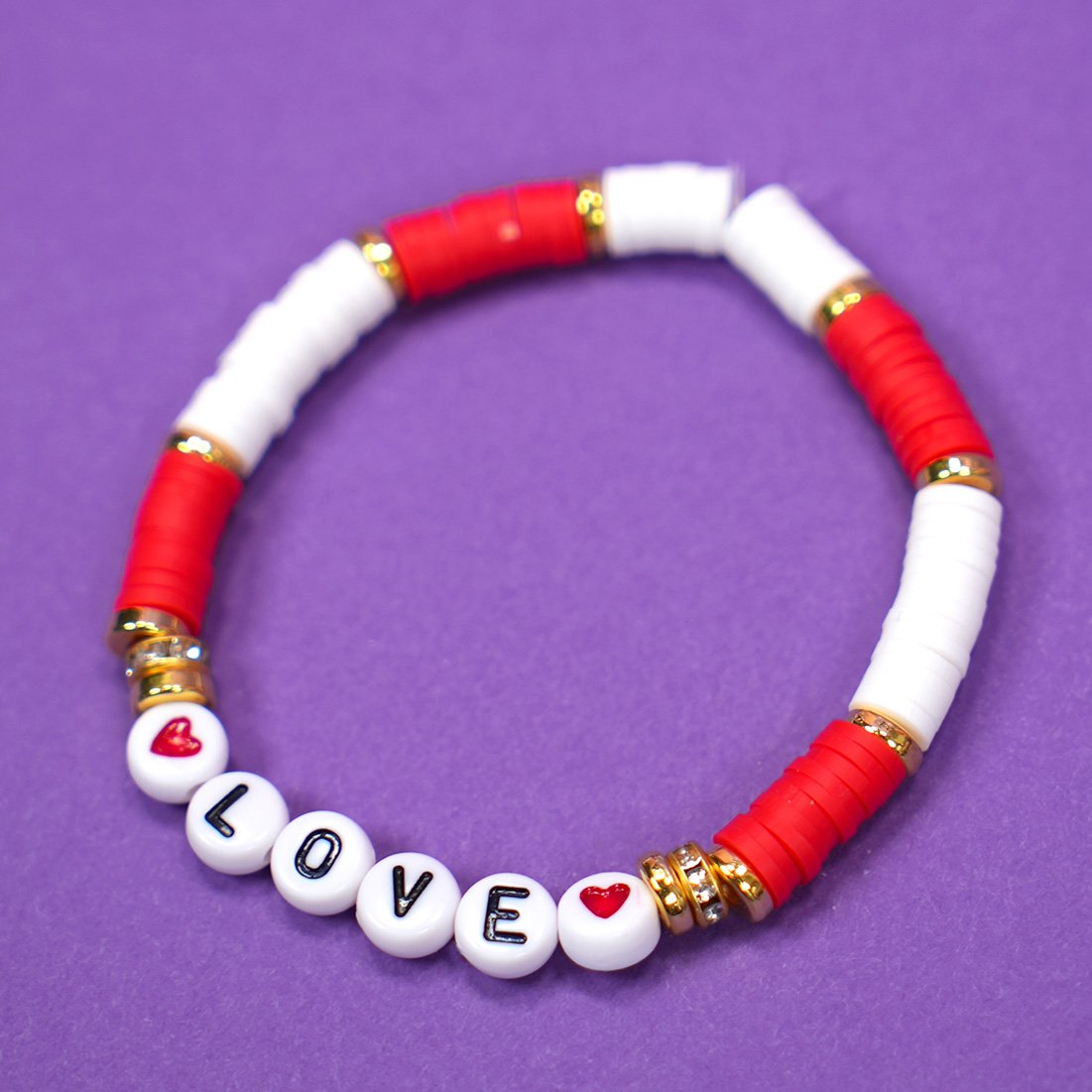 Close up of red and white beaded "LOVE" bracelet for Valentine's Day